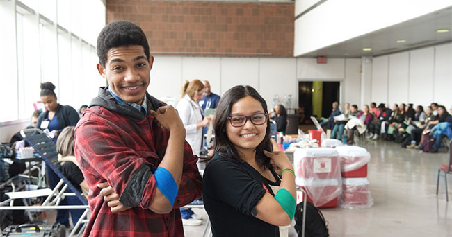 two students smiling after donating blood