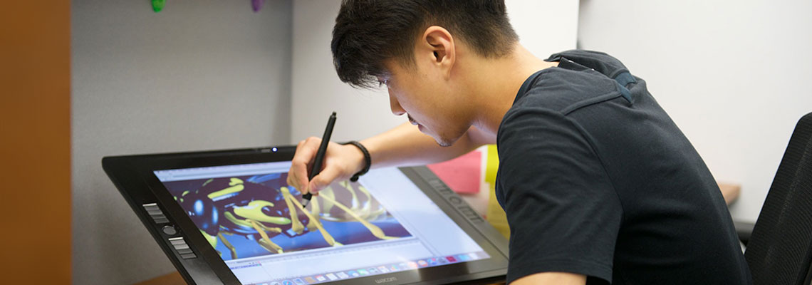 student drawing on tablet