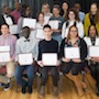 students holding their certificates from Out in Two program