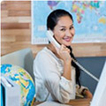 woman answering phone at desk in a travel agency
