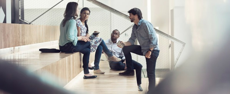 several college students having a discussion in an office building