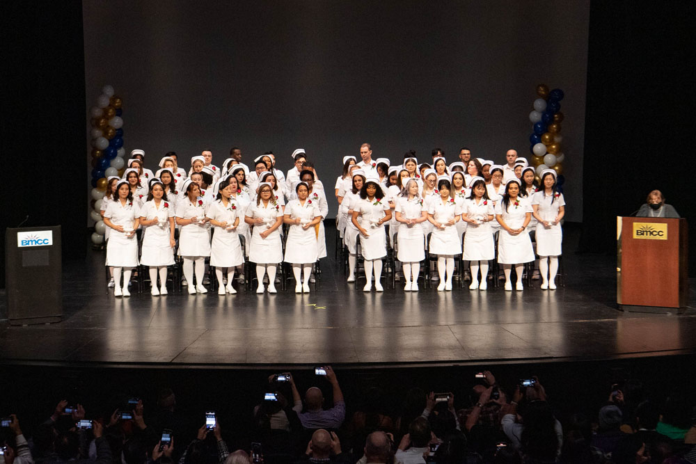 Nursing graduates on stage