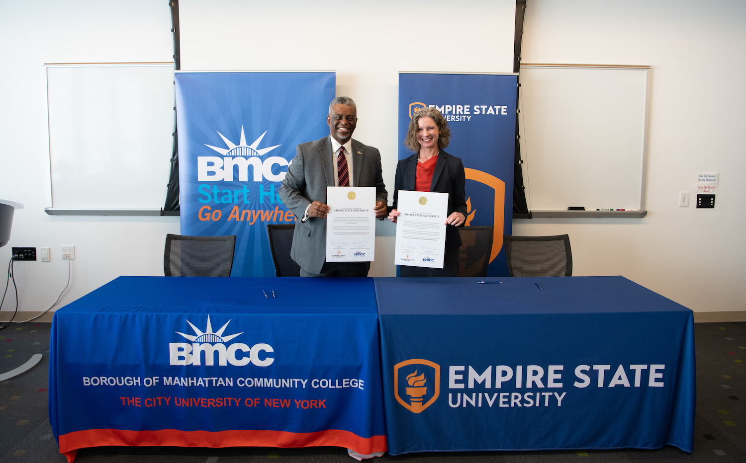 BMCC President Anthony E. Munroe and SUNY Empire State University President Lisa Vollendorf sign a memorandum of understanding and ceremonially acknowledged a transfer agreement between the two institutions.