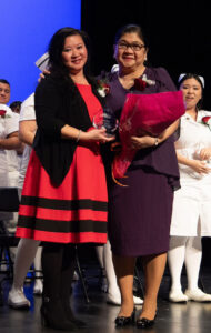 Judy Eng, at left with award
