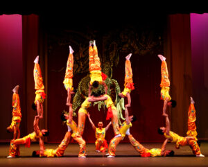 acrobats in colorful costumes doing different poses
