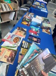 assortment of books displayed on a long table