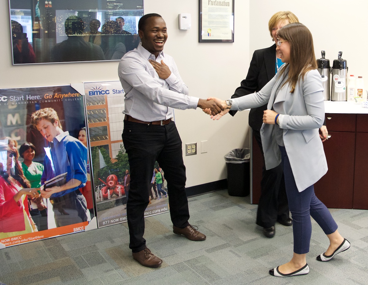 Scholarship recipient Norbesida Bagabila receives congratulatory handshake from Jack Kent Cooke Foundation Director Cecilia Marshall.