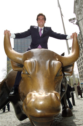 BMCC graduate Bruno Ocampo on the Charging Bull near Wall Street in New York City.