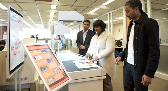 BMCC students in A. Philip Randolph Memorial Library using the KIC scanner.