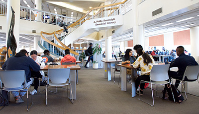 Students working at tables in the library